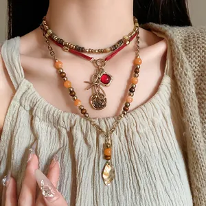 Detail shot of vintage ethnic beaded multi-layer necklace with red stone pendant