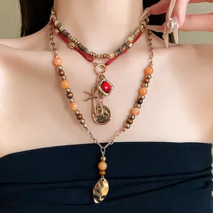 Vintage bohemian multilayered beaded necklace with red stone and coin pendants