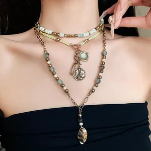 Close-up of a layered ethnic beaded necklace with bow and leaf-shaped pendants