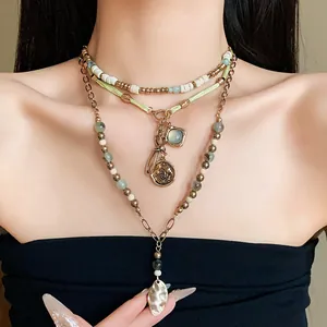 Detailed view of a multi-layer ethnic beaded necklace featuring vintage coin charms