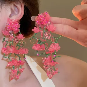 Exaggerated pink floral beaded tassel earrings featuring green vine-like details for women