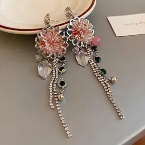 Exquisite silver floral earrings with sparkling crystal tassels and green stone accents