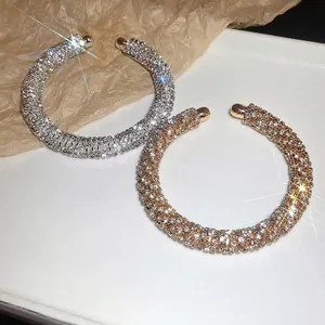 High-end luxury rhinestone encrusted open cuff bangles in silver and gold metal finishes