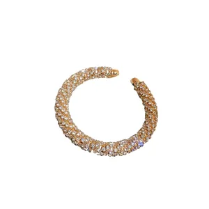 Sparkling gold-plated open cuff bracelet with full rhinestone spiral threaded design