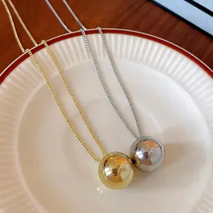 Minimalist polished round ball pendant necklace in gold and silver finish