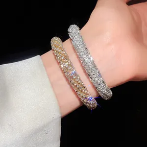 Detailed macro view of gold and silver rhinestone-encrusted spiral open bangles