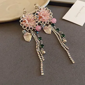 Detailed close-up of sweet flower leaf crystal tassel earrings with sparkling rhinestones