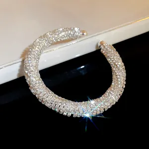 Detailed macro view of luxury rhinestone inlaid threaded circular open cuff bracelet