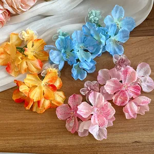 Dettaglio di orecchini pendenti fatti a mano in chiffon di seta in vari colori