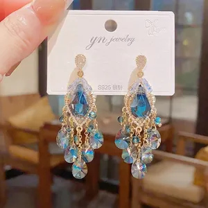 Detailed macro view of vintage teardrop earrings with cascading blue crystal tassels