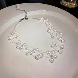 Elegant multi-layer pearl choker necklace with floating illusion strings on a plate