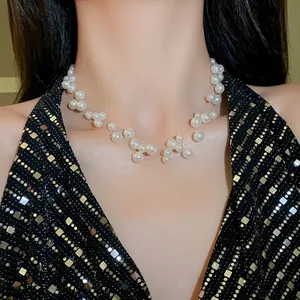 Elegant multi-layer staggered white pearl necklace worn by model on black sequin top