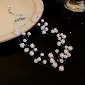 Elegant multi-layer staggered white pearl necklace with transparent floating line design