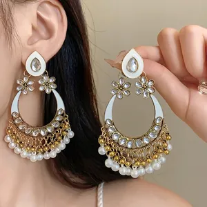 Elegant ethnic style teardrop earrings featuring crystals and delicate pearl tassels