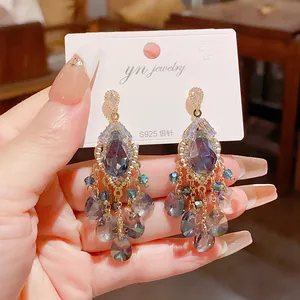 Close-up of vintage palace style chandelier earrings with crystal teardrop tassels