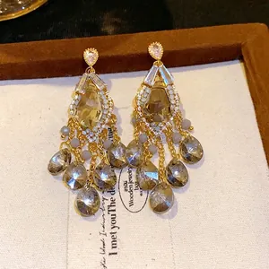 Elegant gold-tone tassel chandelier earrings with zircon studs and teardrop glass beads.
