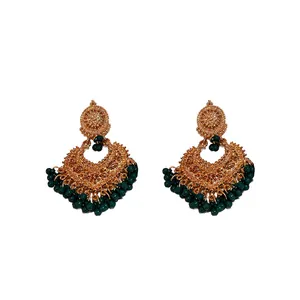 Vintage ethnic drop earrings with ornate gold-toned metal and dark green beads.