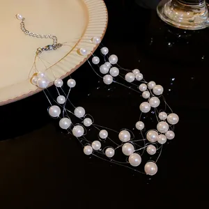 Close-up detail of multi-layer pearl necklace featuring elegant floating interlaced design