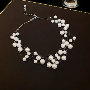 Detail view of multi-layer floating pearl necklace with elegant interwoven design