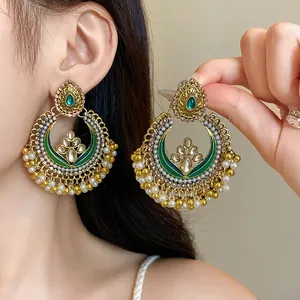 Exquisite ethnic style drop earrings with green stones and pearl tassels in gold finish
