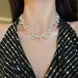 Macro view of an elegant multi-layered white pearl choker necklace on a model's neck