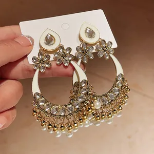 Detail of vintage ethnic style pearl drop earrings with rhinestones and flower accents