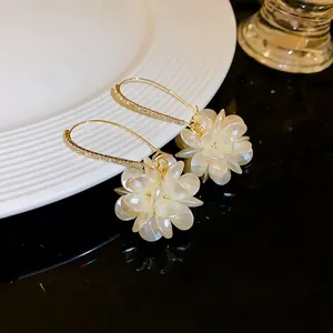 Elegant white cluster floral drop earrings featuring rhinestone-encrusted gold hooks for women