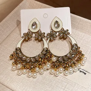 Close-up view of vintage ethnic earrings with pearls, rhinestones and floral motifs