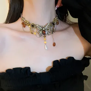 Elegant vintage butterfly zircon choker necklace with amber and pearl drops shown on a model.