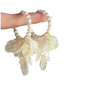 Elegant pearl hoop earrings featuring white cascading petal tassels for a French style.