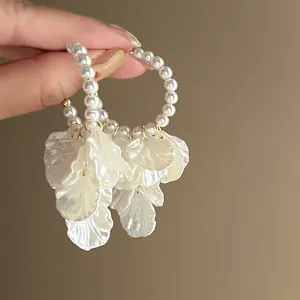 Elegant pearl hoop earrings with cascading white flower petals for a chic look