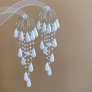 Vista detallada de pendientes de perlas con flecos de gota de circón plateado