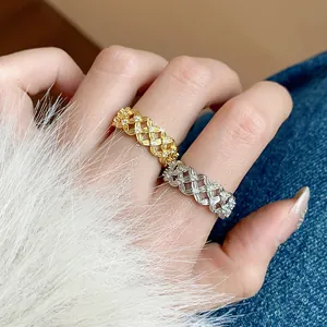 Detailed view of gold and silver plated zircon rings with intricate hollowed patterns.