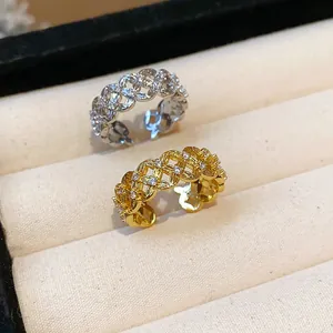 Detailed macro view of gold and silver plated hollow lattice rings with zircon