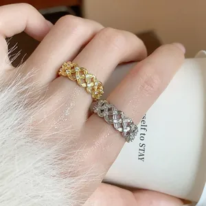 Detailed view of exquisite 18k gold plated hollow flower rings with zircons on finger