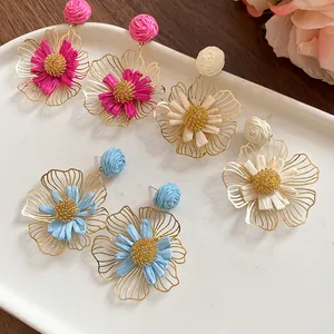 Elegant bohemian hand-woven raffia flower drop earrings in pink, cream and blue colors