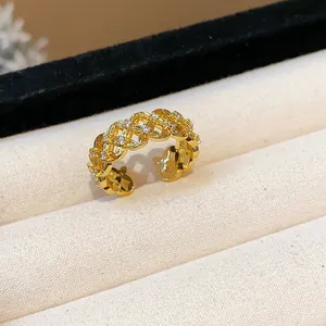 Detailed macro shot of an 18k gold plated hollow flower ring with sparkling zircon.