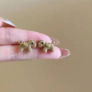 Elegant brown flocked puppy stud earrings with golden saddle accents and silver needles
