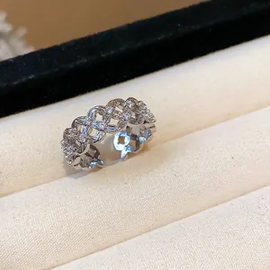 Close-up detail of silver-toned hollow flower lattice ring with cubic zirconia