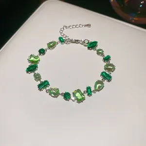 Elegant silver-tone chain bracelet featuring multi-shaped green zircon gemstones
