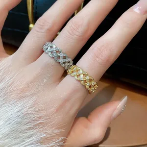 Close-up view of elegant 18k gold plated zircon hollow flower rings on fingers