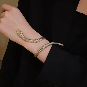 Elegant gold-toned snake-shaped wrap bracelet featuring detailed scale texture on wrist