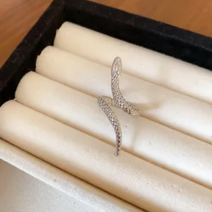 Close-up of a silver snake-shaped wrap ring with intricate scale texture detail