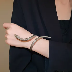 Detailed macro shot of a textured silver snake wrap-around open bracelet on wrist