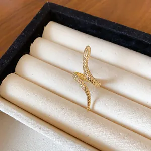 Detailed close-up of a gold-colored snake ring featuring realistic scale textures