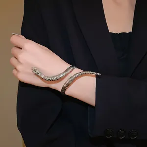Close-up of a stylish silver-toned snake-shaped cuff bracelet worn on a female wrist.