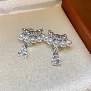 Detail view of elegant French zircon waterdrop pendant pearl clip-on earrings for women