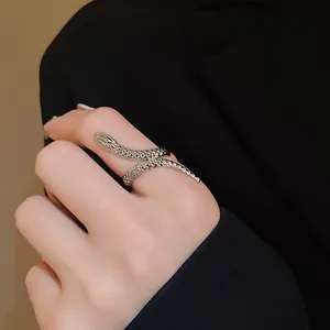 Detailed close-up view of a stylish silver snake-shaped open ring worn on a hand