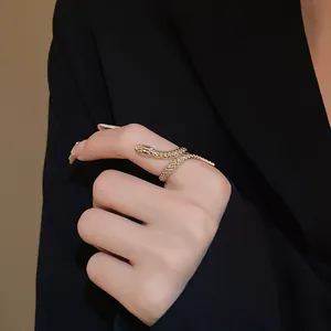 Exquisite gold-tone snake wrap ring featuring detailed scale texture on model's finger