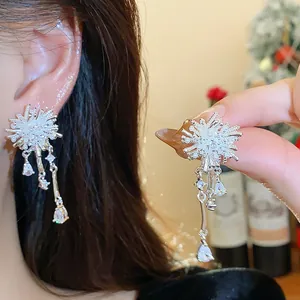 Elegant silver fireworks dangle earrings with zirconia, detailed close-up of fashion jewelry